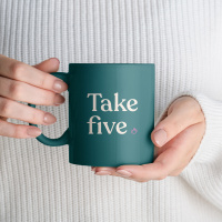 Female hands holding white mug mockup with blank copy space for your advertising text message or promotional content. Girl in white sweater holding white porcelain coffee mug mock up, close up